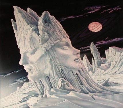 Two faces carved of snow, a male on one side a female on the other, sharing a crown.